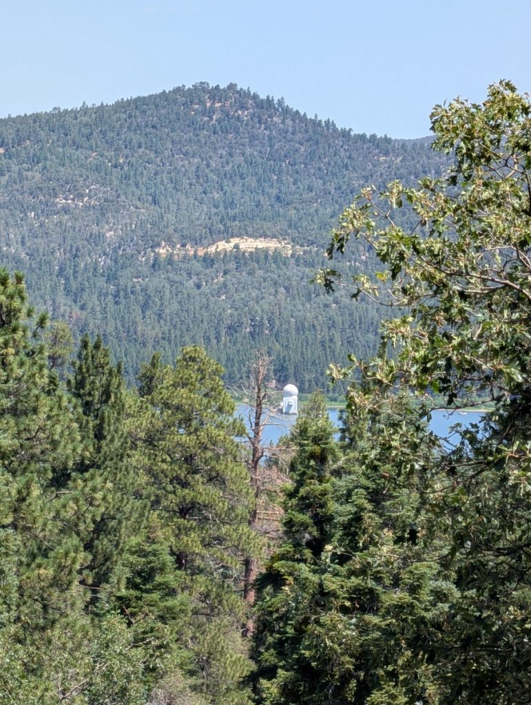 view of the observatory through the trees on pine knot trail big bear lake california