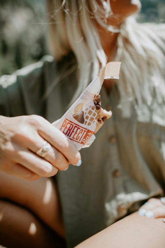 woman eating a hiking snack